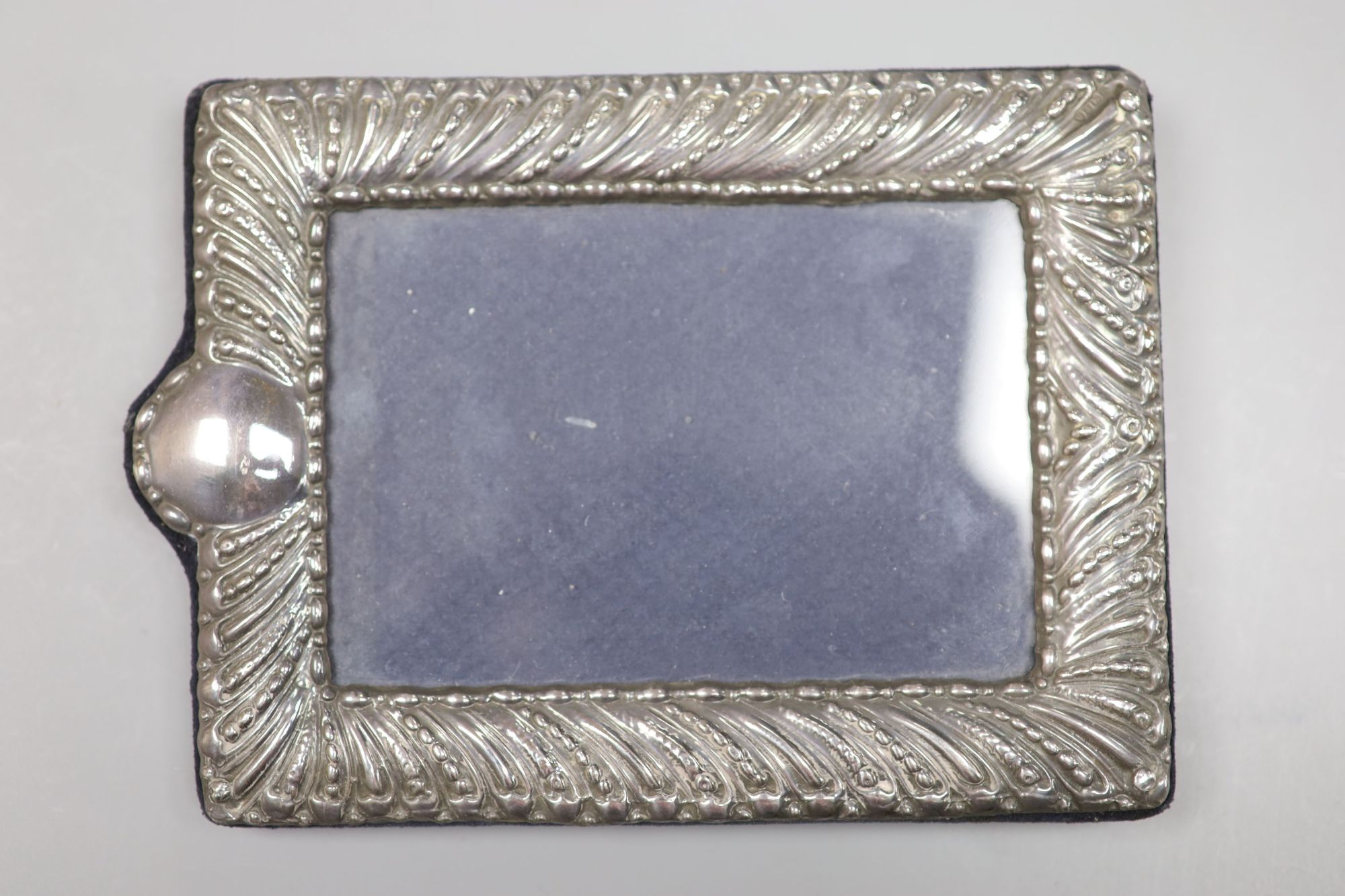 A George V oval silver photograph frame with reeded and beaded border, London 1910, 21.5cm and three other silver frames.